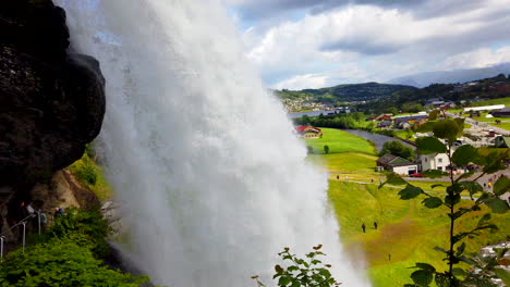 awesome steinsdalsfossen waterfall near steine, norway tilt up - down from behind falls 4k prorezhq