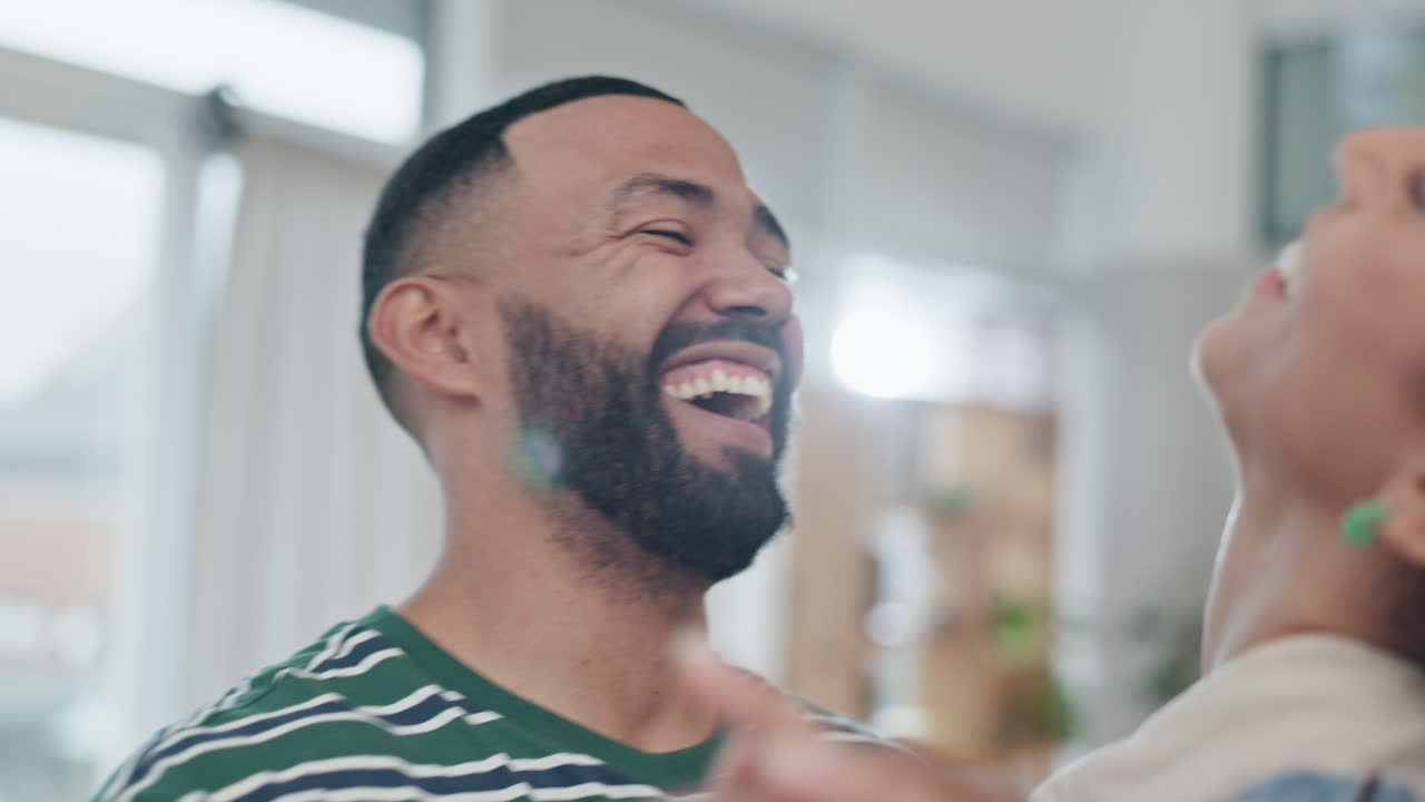 Love, dance and a couple laughing in the living