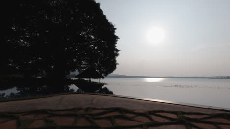 a serene view of a resort by the kabini river, showcasing an infinity pool and tranquil surroundings