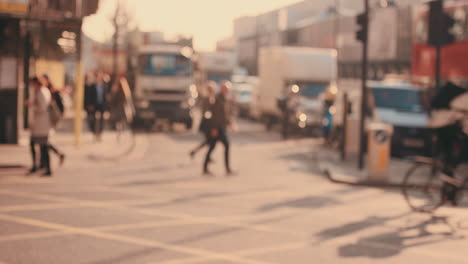 anonymous crowd of people walking cycling bicycles commuters london city street slow motion