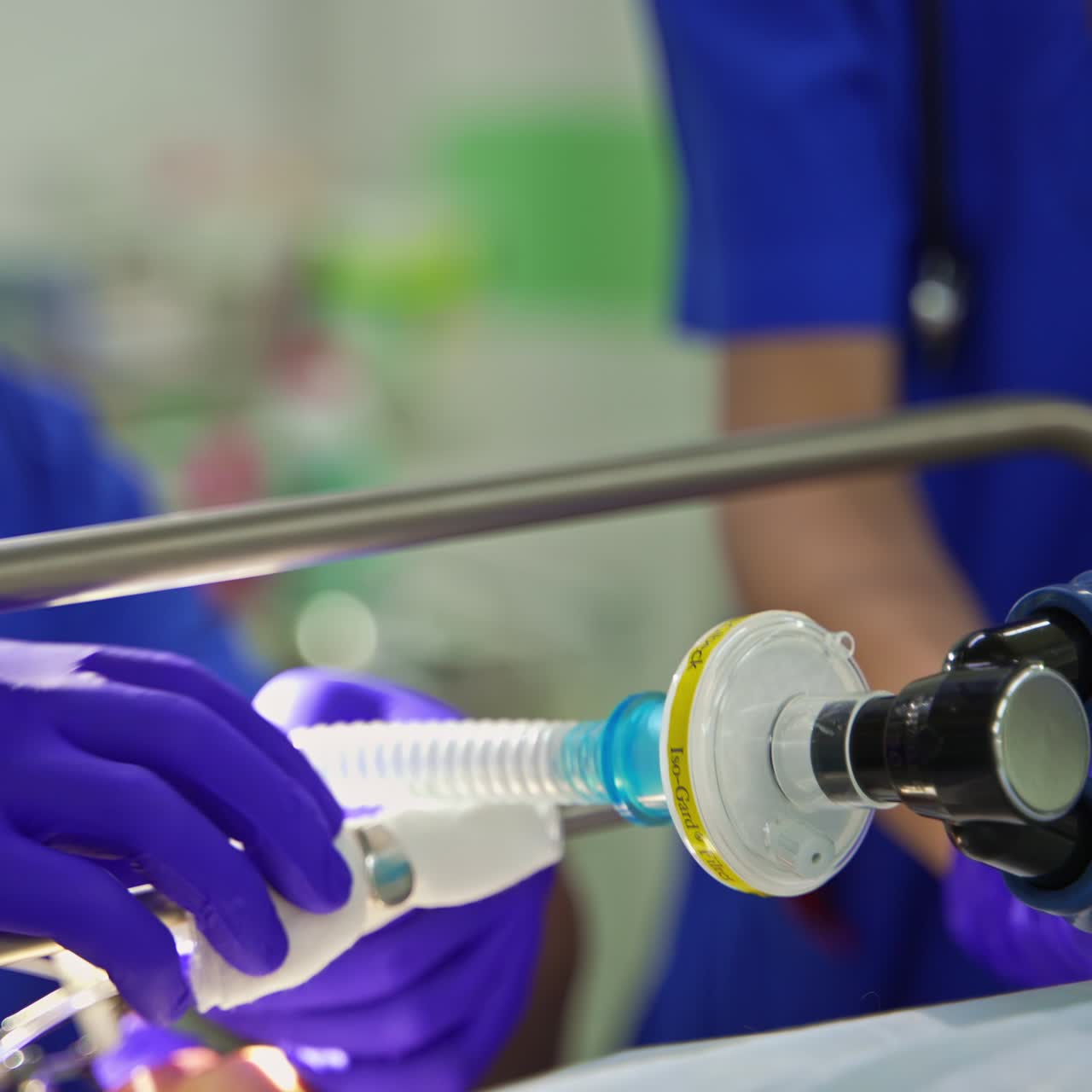 Doctors in blue uniforms arranging equipment for operation. Preparation for surgery in modern clinics. Close up. Blurred backdrop
