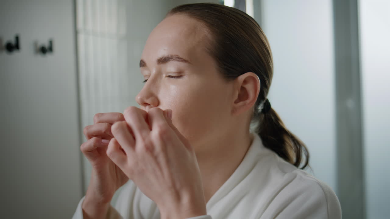 Closeup girl flossing teeth in mirror reflection. lady doing dental