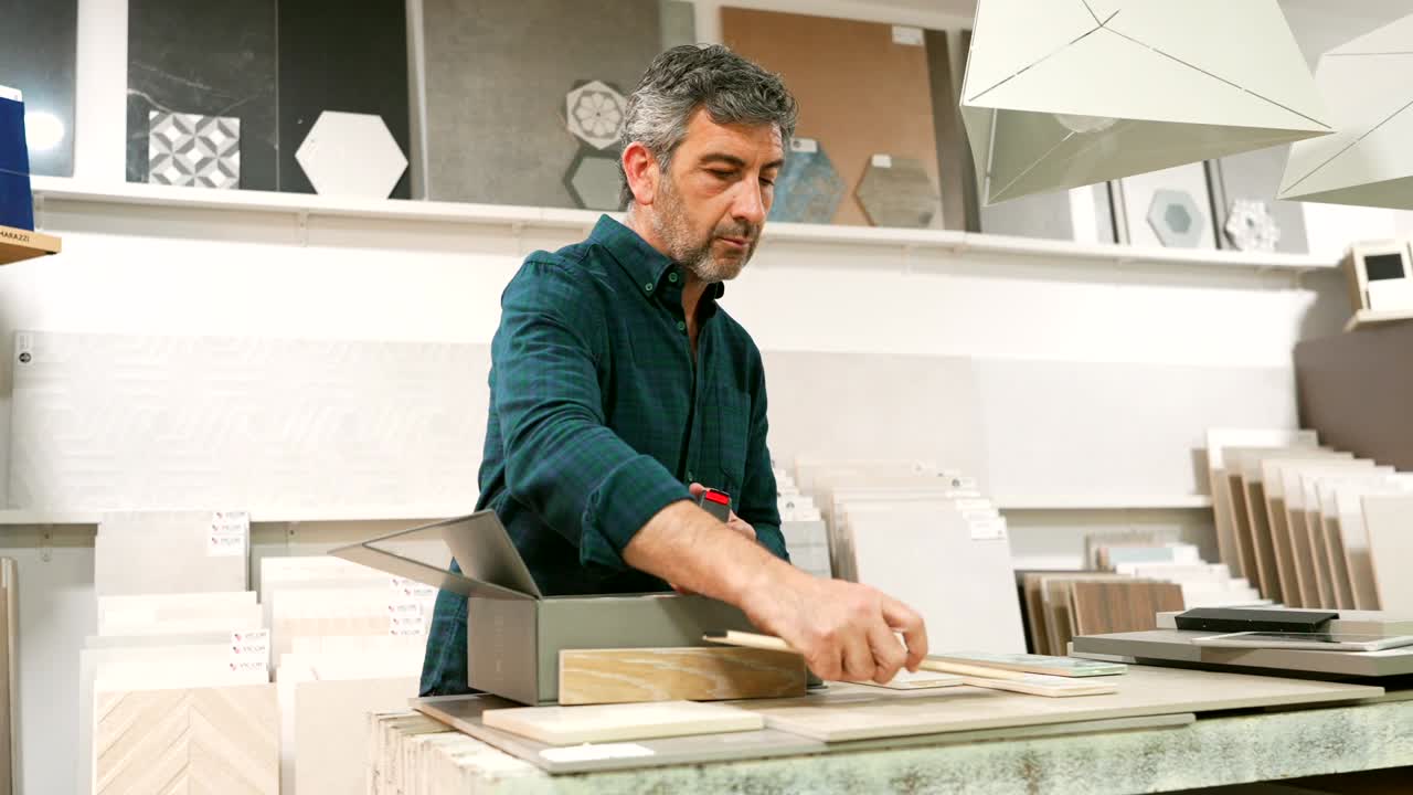 Man choosing tiles in a shop