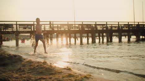 kid running on the beach slow motion