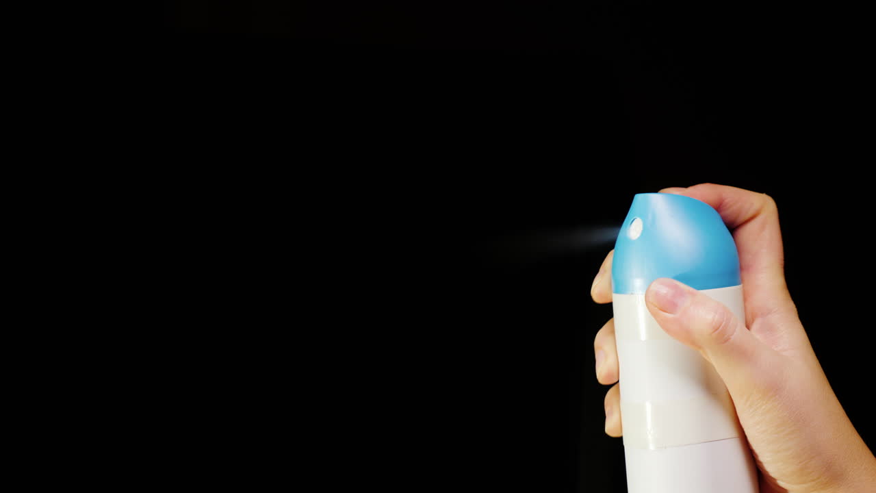 Hand With An Aerosol Can Spray Spray On A Black Background 4K Video