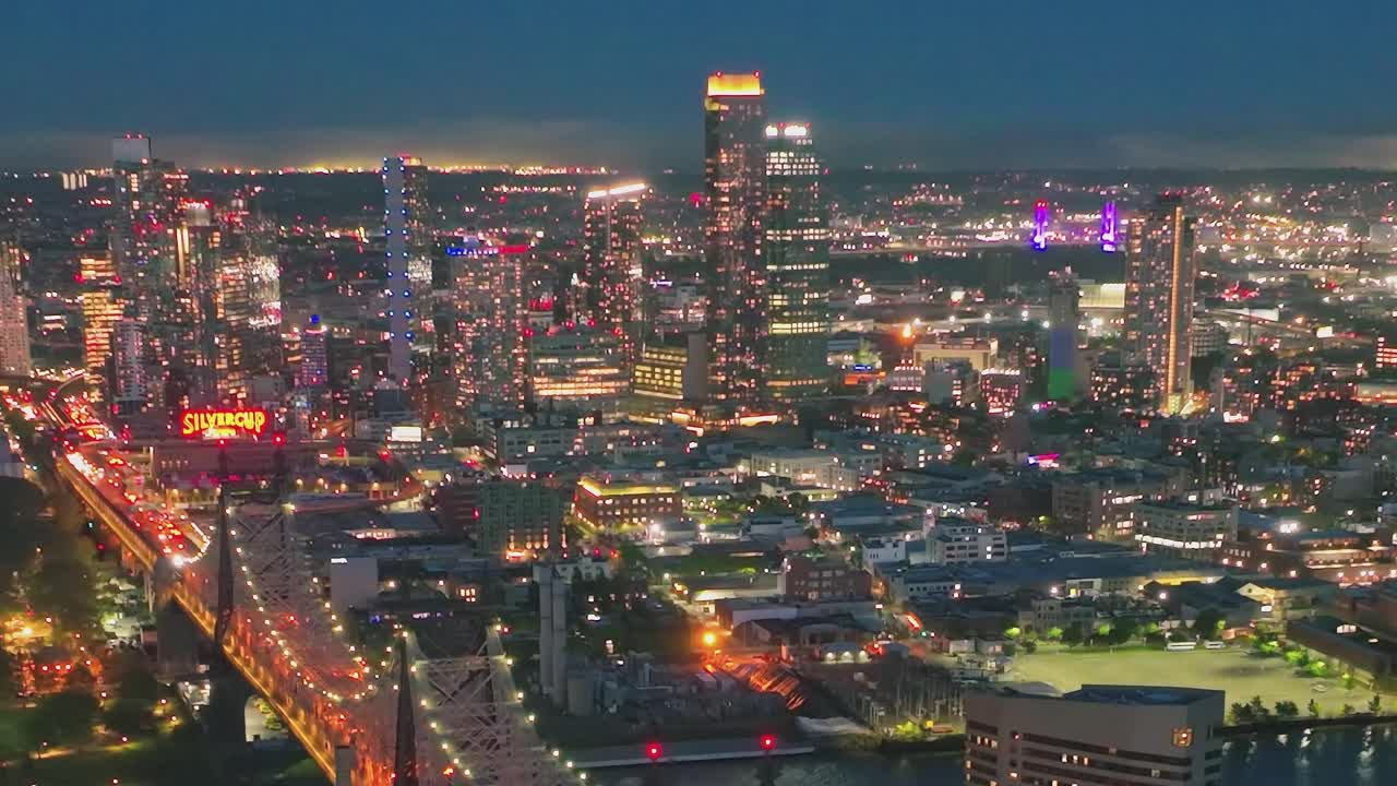 Nighttime Cityscape with Illuminated Bridge and Skyscrapers