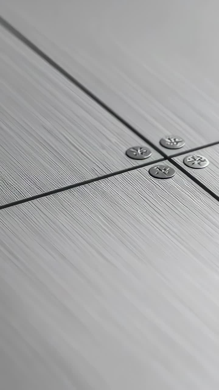 Vertical video: Shifting highlight making camera panning panel seam in lab light, showing rivets