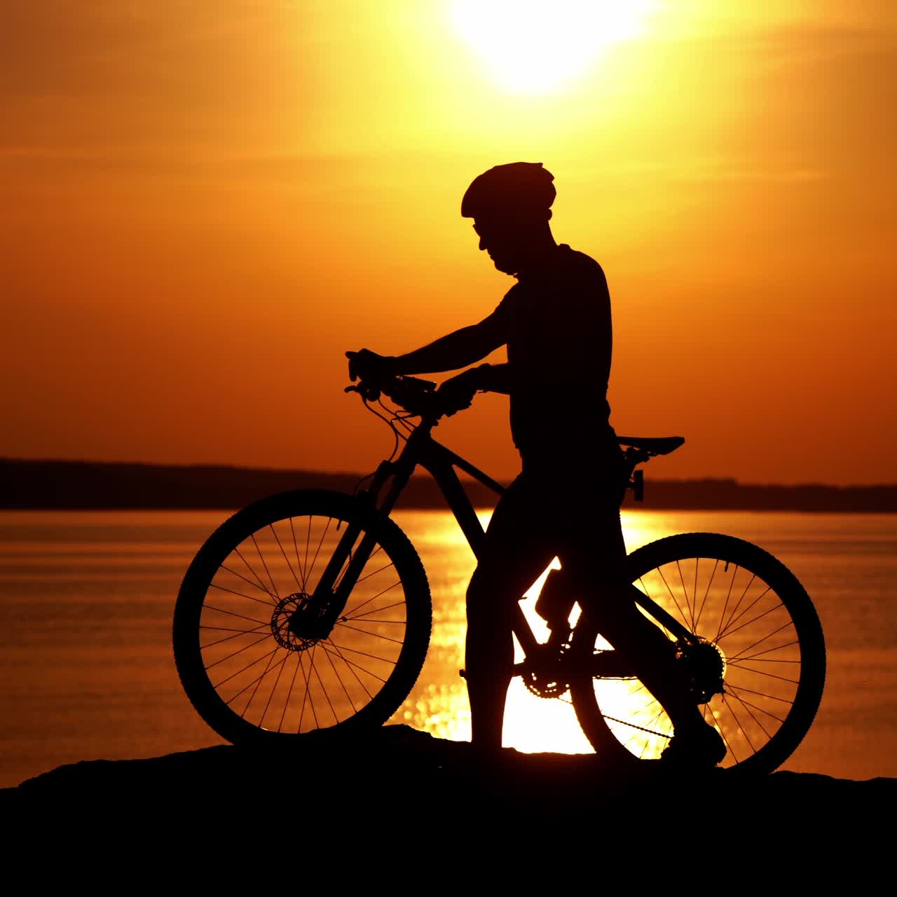 Biker riding on bicycle on hill