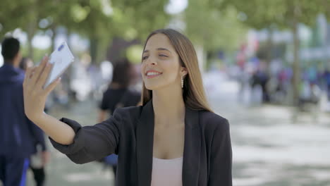 attractive girl taking selfie with smartphone outdoor