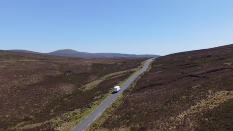 the last mile: a drone tracking a delivery van in a rural road in wicklow mountains