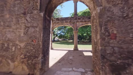 fpv drone flight through ancient building ruin during sunny day in san cristobal - engombe ruin