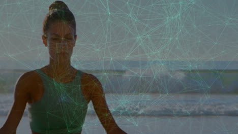 meditating woman on beach with digital network animation in background