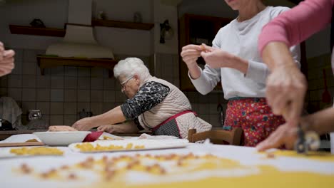 crop senior woman cooking tortellini at home