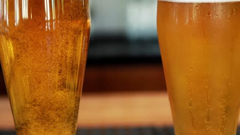 close-up of two chilled glasses of beer