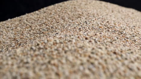 close-up of sand grains with a dark background