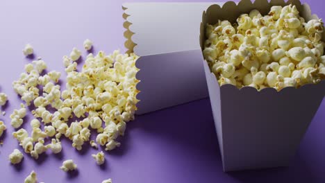 Video-of-close-up-of-popcorn-on-blue-background