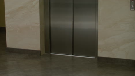 woman exiting the elevator in the hotel hall