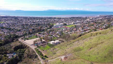 2020 - aerial over the pacific coastal green hills and mountains behind ventura california including suburban homes and neighborhoods 3