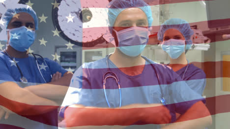 Animation-of-flag-of-united-states-of-america-waving-over-surgeons-in-operating-theatre