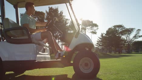 golfer driving in his golf buggy