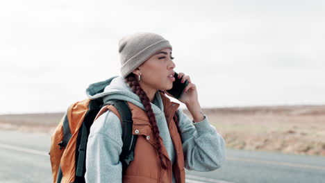 woman searching for a signal with her phone while backpacking