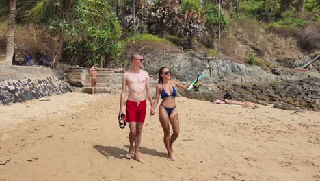 couple snorkeling at tropical beach