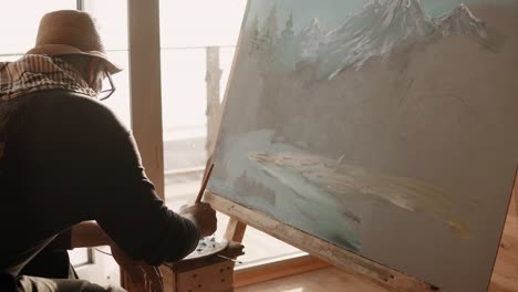 elderly artist painting a landscape