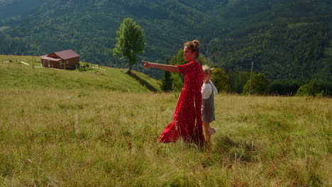 Woman-girl-enjoy-walking-on-mountain-meadow.-Mother-resting-with-daughter.