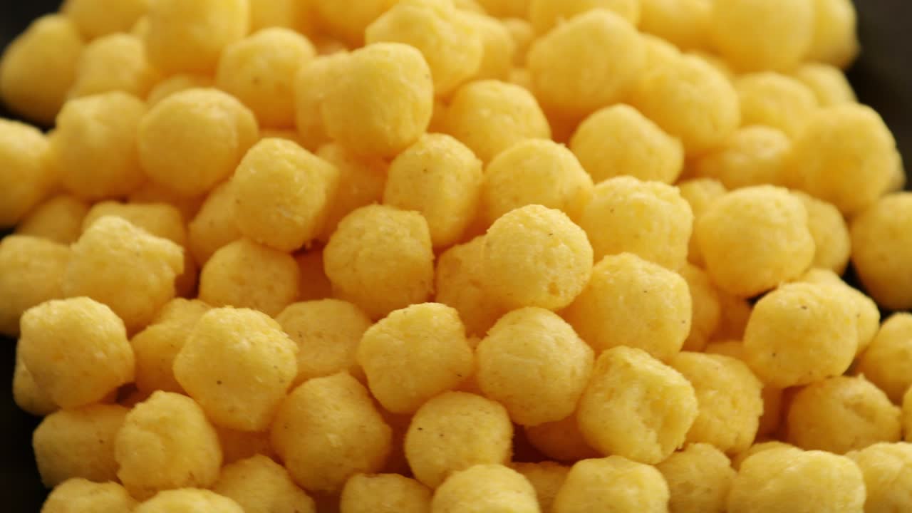 Puffed golden cheese balls rotating 2