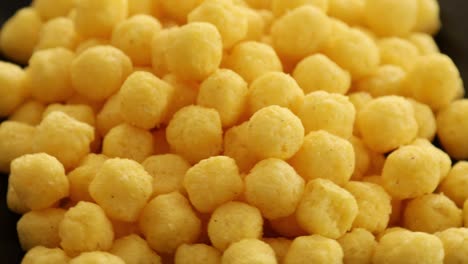 puffed golden cheese balls rotating 2