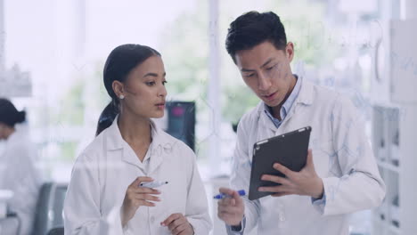 Two-scientists-working-together-using-a-tablet