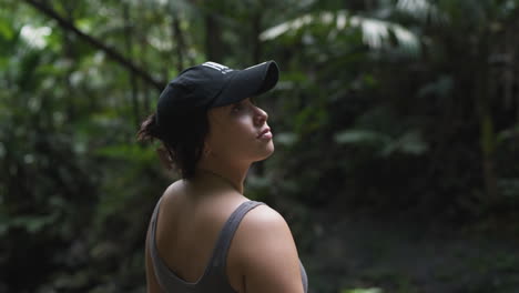 slow motion shot of a female looking and smiling in the rainforest in puerto rico