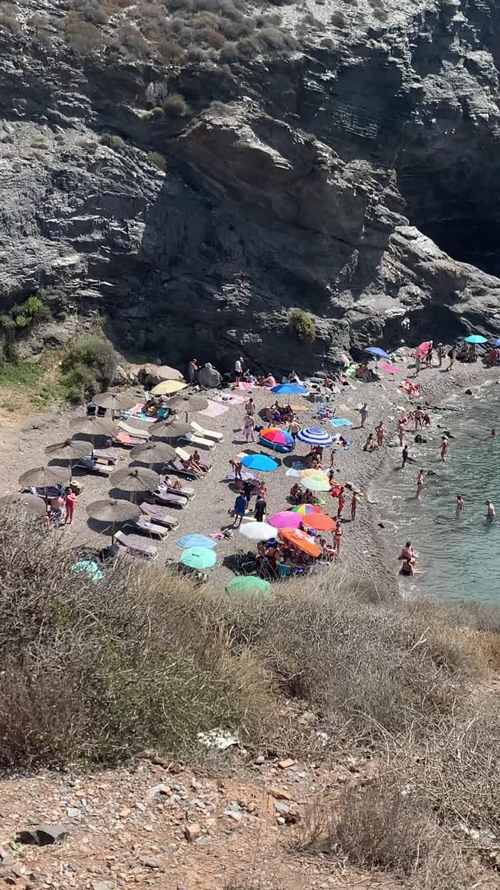 People at the hidden small beach in La Manga, Murcia, enjoying the coolness of the water during the hot summertime