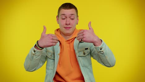 teen stylish man feeling very proud pointing himself, looking self-confident overjoyed by success