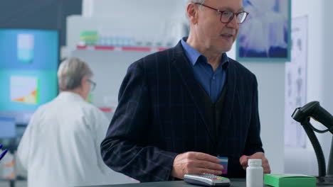 Elderly-customer-at-drugstore-checkout