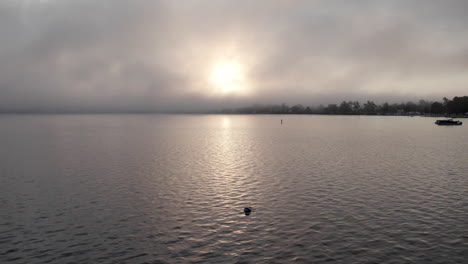 epic sunrise on the lake with clouds, drone shot