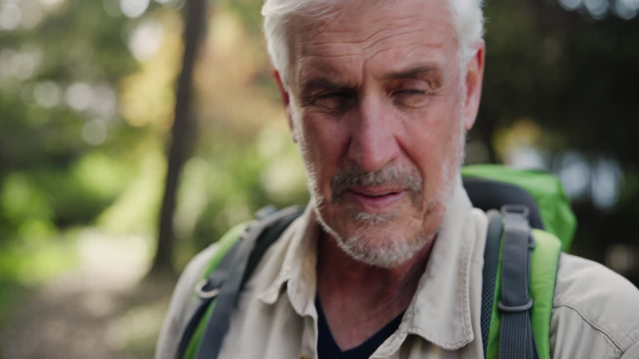 Portrait of a senior man hiking with a backpack