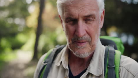 portrait of a senior man hiking with a backpack