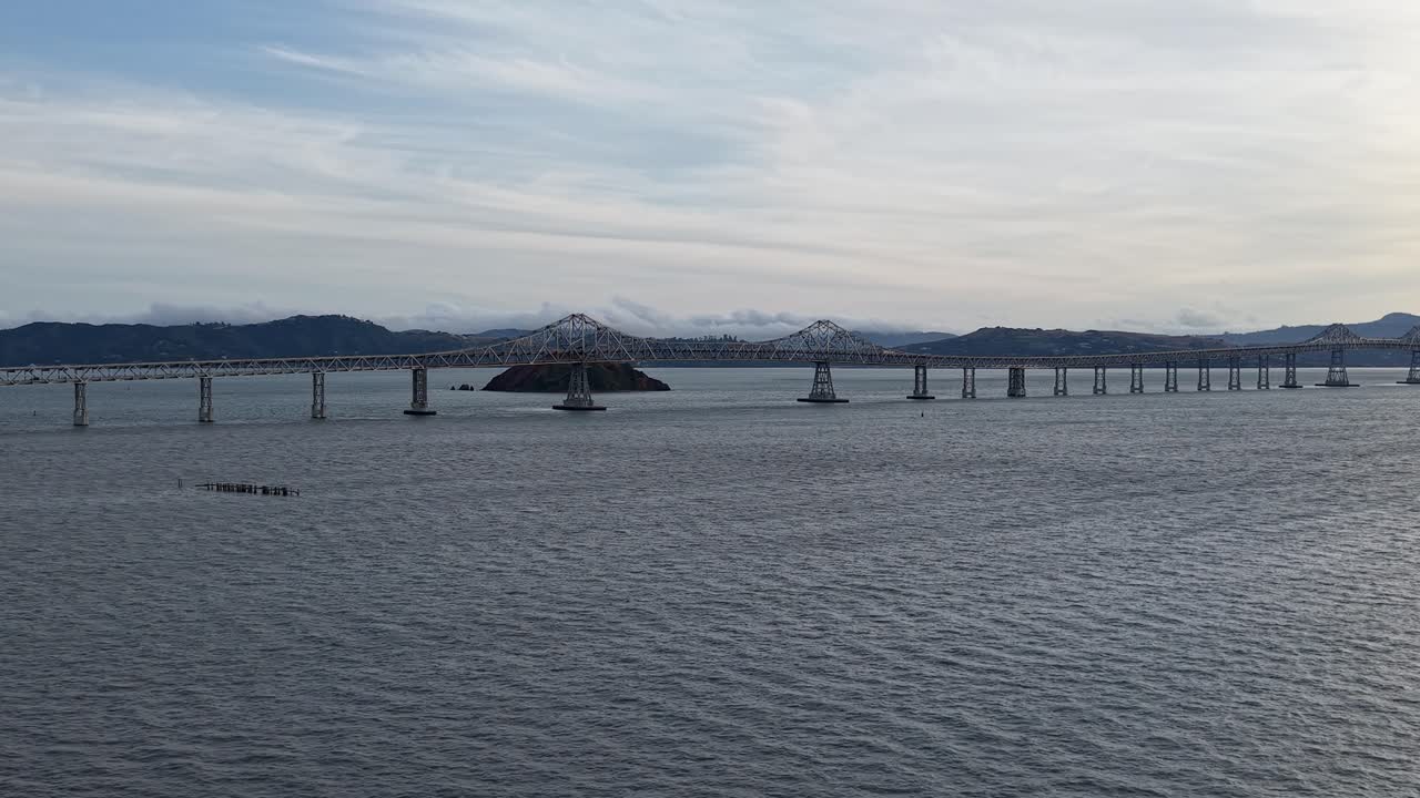 Glide above the bridge and take in the subtle shifts in light, traffic, and bay textures that make the scene feel alive.