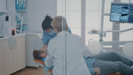 team of experts extracting tooth at oral care clinic