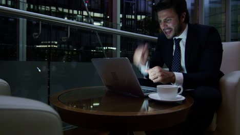 arabic male business traveller laptop night hotel atrium