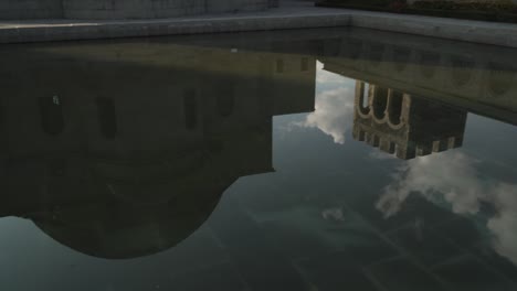 panorama shot: fountain reflection of medieval casle with middle eastern