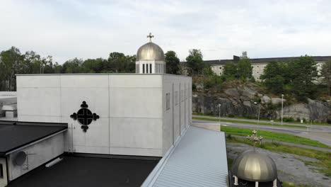 back view of orthodox church in gothenburg with metal globe and cross, aerial