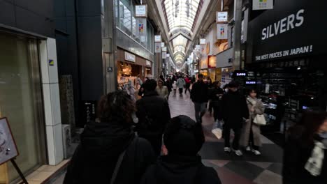 pedestrians walking through a busy shopping arcade