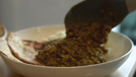 Close-Up-of-Ladle-Pouring-Food-into-Bowl