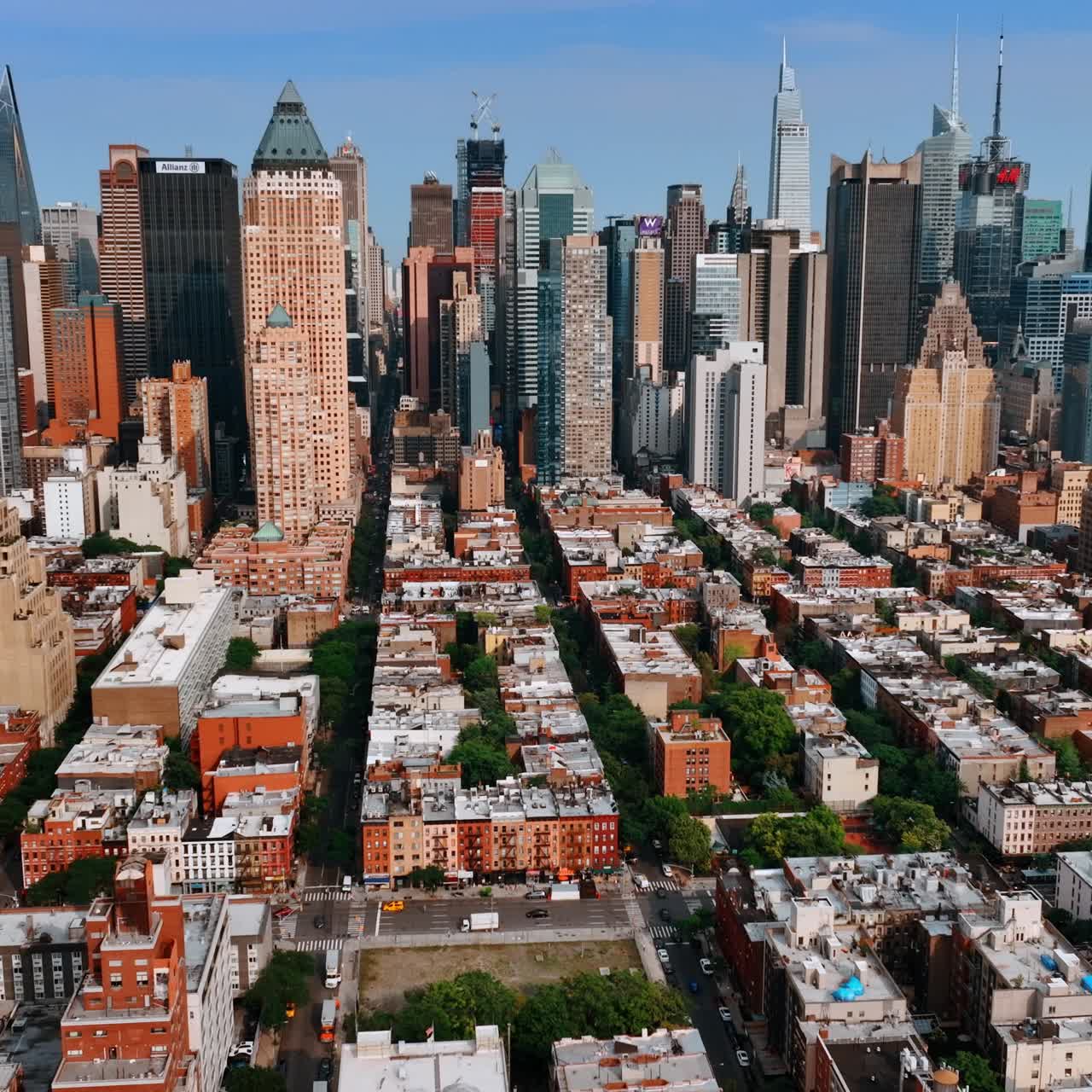 Approaching gorgeous skyscrapers in the New York midtown. Sunny panorama of the city from aerial perspective