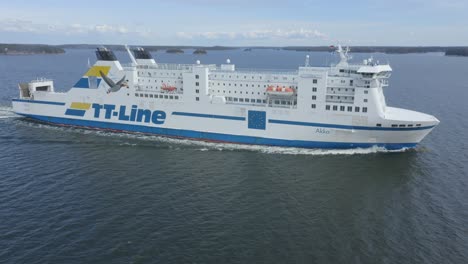 tt line car ferry akka making way ahead in finnish archipelago. low altitude aerial circling view.