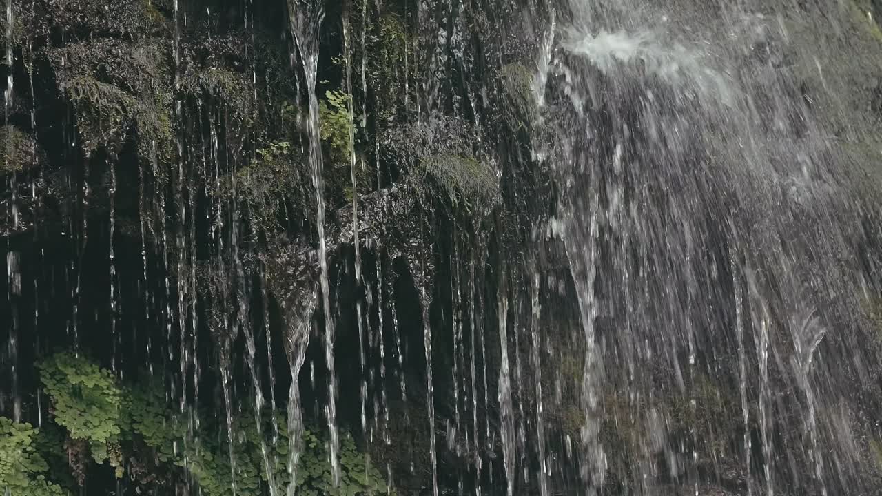 Waterfall cascading down mossy rocks