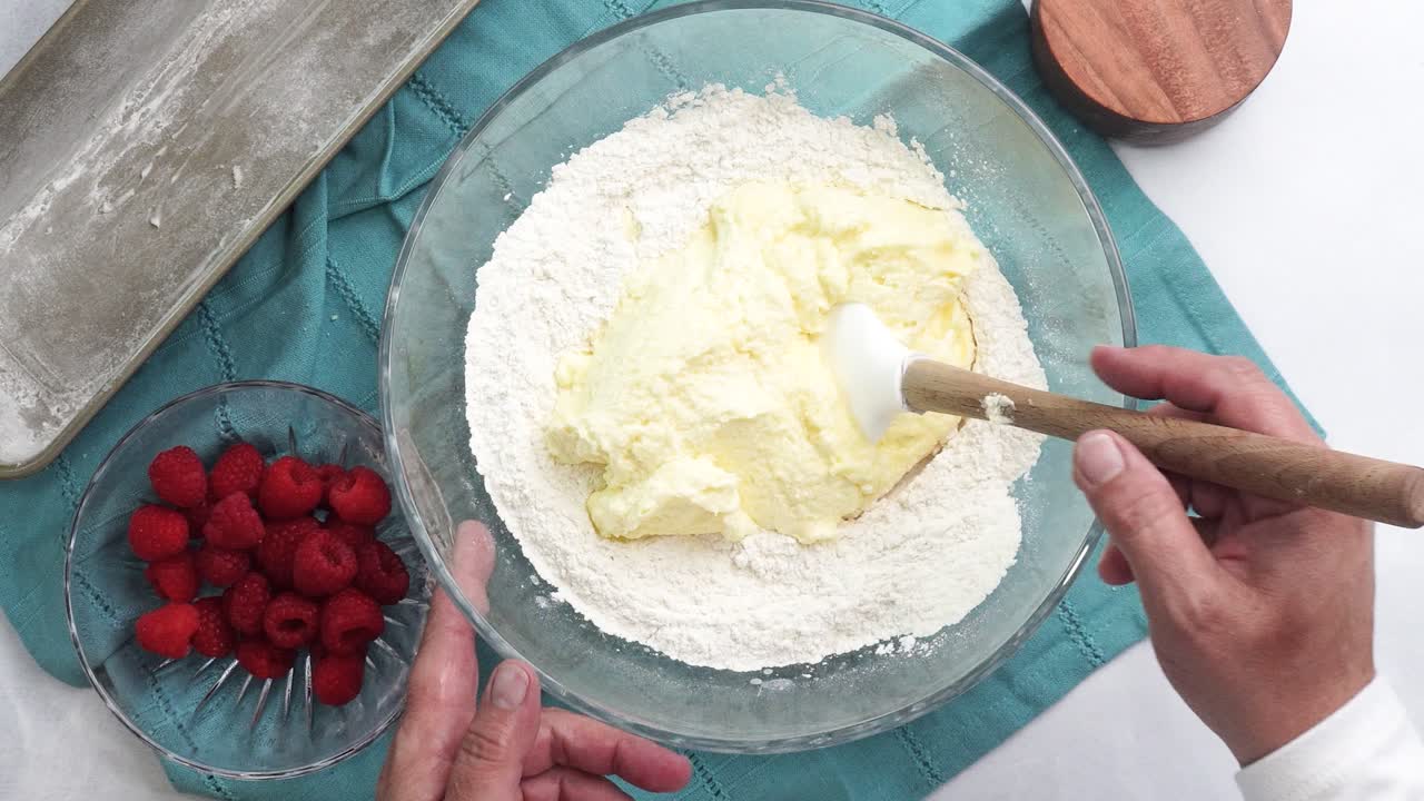 Making a dessert called Red Raspberry Tea Cake made with fresh berries and vanilla buttercream frosting. Great for Tea Parties. Mixing the vanilla cake batter in a bowl and combing the ingredients