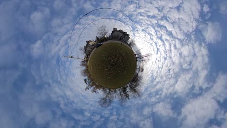 tiny planet timelapse with clouds in a city park